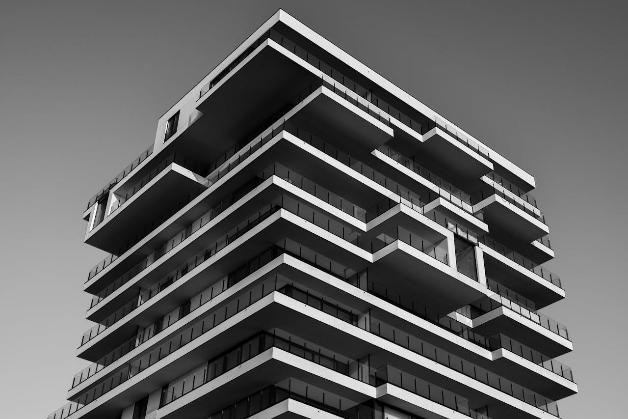 about-01 A striking black and white photo of a modern high-rise building with unique geometric designs.